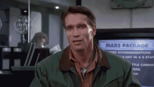 a man in a green jacket is standing in front of a tv screen that says mars package