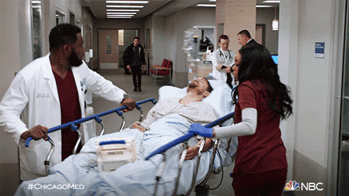 a man is on a stretcher in a hospital hallway with #chicagomed written on the bottom right