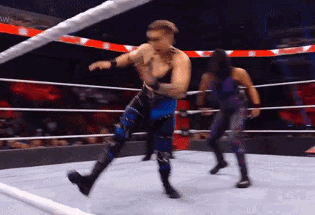 a wrestler is kicking another wrestler in the face during a match
