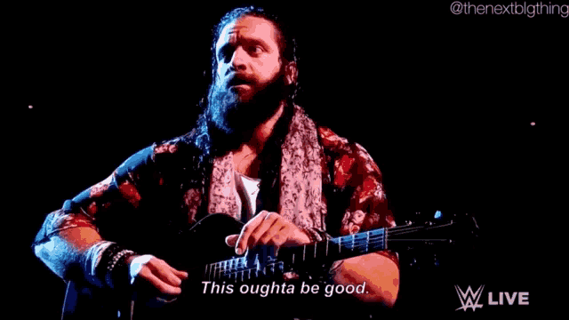 a man with a beard is playing a guitar on a stage and says `` this oughta be good '' .