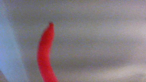 a blurry picture of a red object on a white background