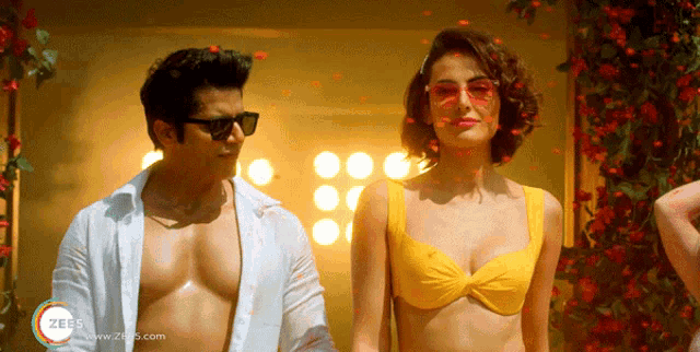 a man in a white shirt and a woman in a yellow bikini are standing next to each other in a scene from zee5