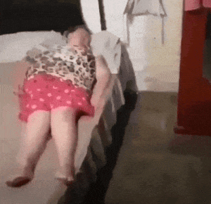 a woman laying on a bed with her legs crossed