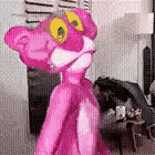 a pink panther is standing in a living room in front of a window .