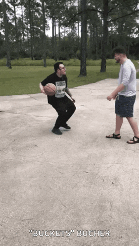 two men are playing basketball and one of them is wearing a shirt that says " buckets " on it