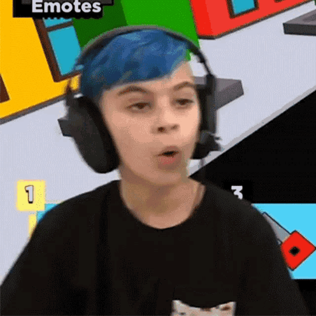 a young boy with blue hair is wearing headphones and making a face .