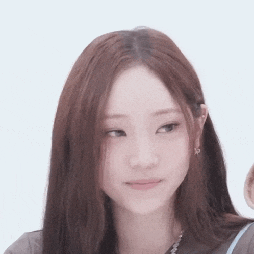 a close up of a woman with long hair and earrings