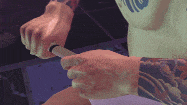 a man with a tattoo on his arm is holding something