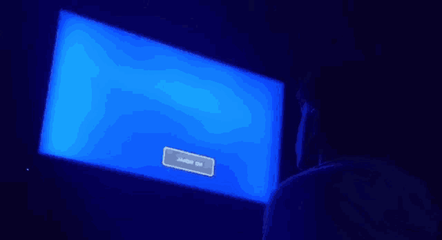 a man is looking at a blue screen that says ' power off ' on it