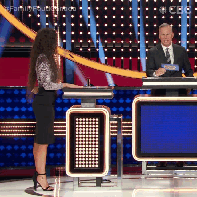 a man and a woman are on a family feud show