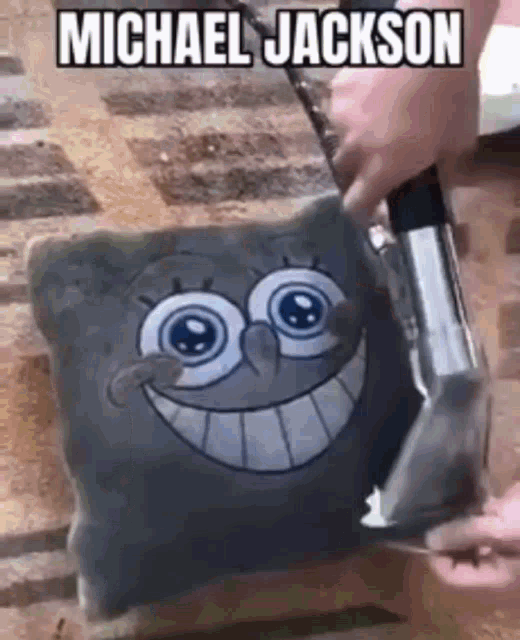 a person is cleaning a pillow with a spongebob face on it