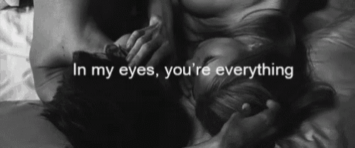 a black and white photo of a man and a woman with the words in my eyes you 're everything