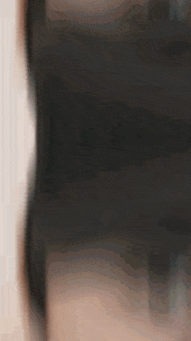 a close up of a person 's face with a blurry background .