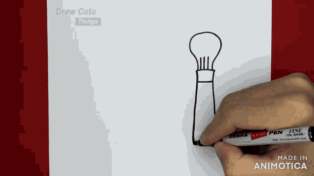 a person drawing a light bulb with a zebra stamp pen