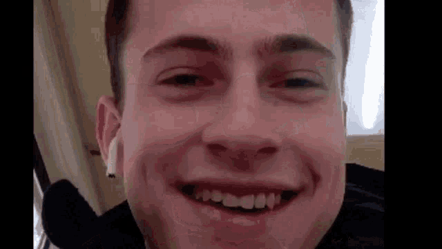 a close up of a man 's face with a smile on it
