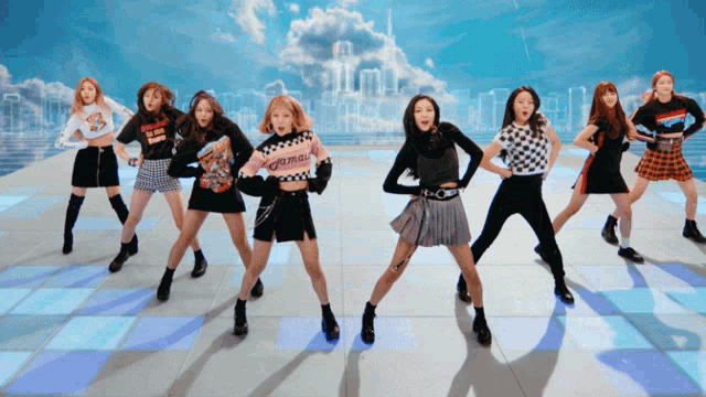 a group of girls are dancing and one of them is wearing a sweater that says ' twice ' on it