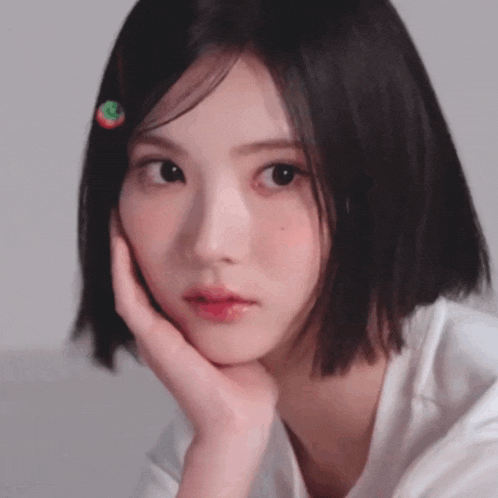 a close up of a girl with a cherry in her hair