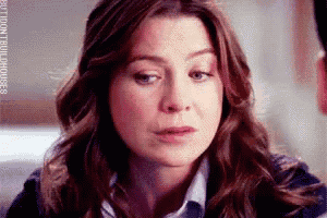 a close up of a woman 's face with a sad look on her face