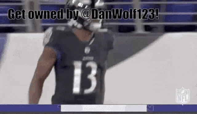 a football player wearing a black jersey with the number 13 on it is standing on the field .