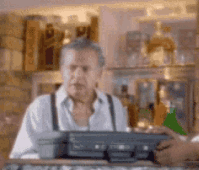 a blurry picture of a man behind a counter with a briefcase