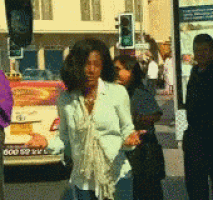 a woman walking down a street with a license plate that says ' a '