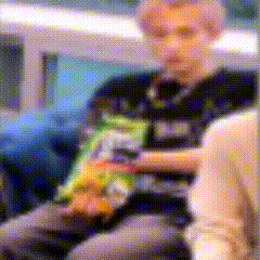 a person is holding a bag of chips in their lap