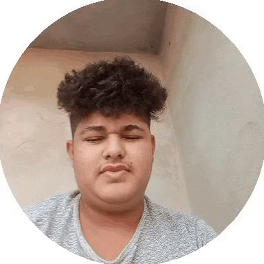 a young man with curly hair is making a funny face in a circle .