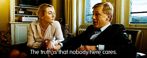 a man and a woman are sitting in a living room and the woman says the truth is that nobody here cares