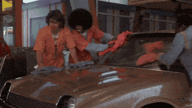 a person is holding a red towel that says ' a ' on it