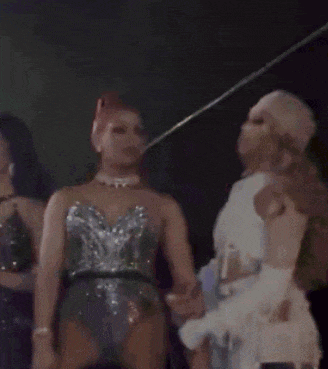 a blurry photo of three women standing next to each other with one wearing a mask