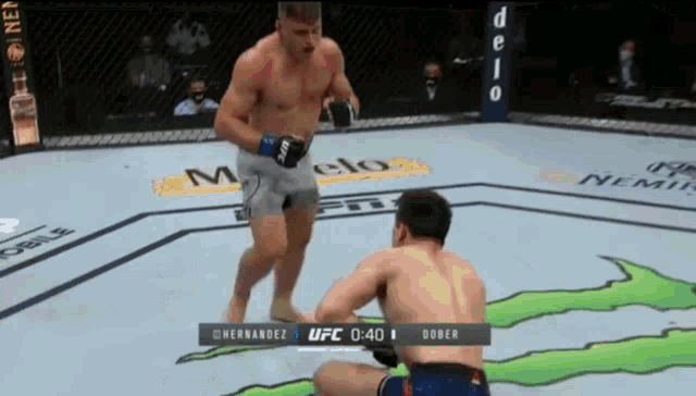 two men are fighting in a boxing ring with a monster on the ground