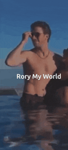 a shirtless man is standing in the water with the words rory my world written on the bottom