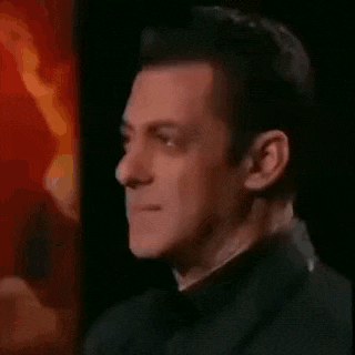 a close up of a man 's face with a red background and a black jacket .