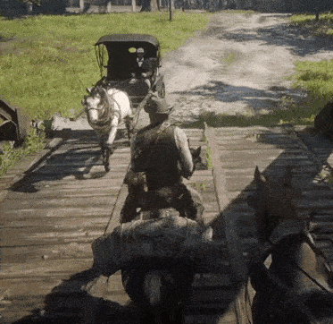a man is riding a horse drawn carriage over a bridge