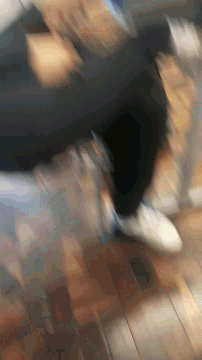 a blurry picture of a person walking down stairs with a brick wall in the background