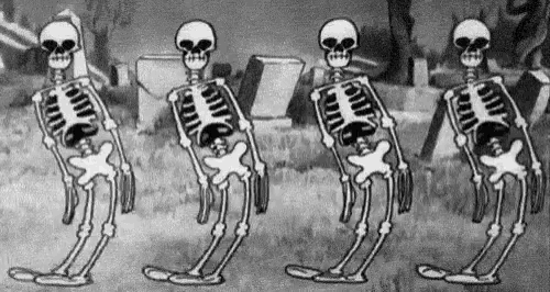 four skeletons are standing next to each other in a cemetery .