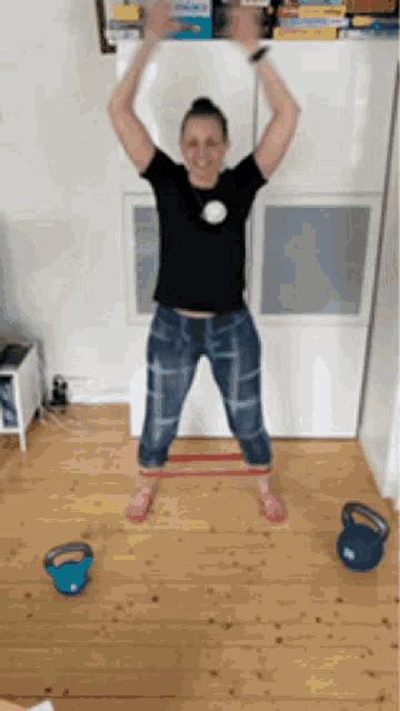 a woman is jumping over a resistance band in a living room .