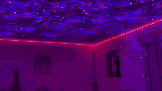 a room with a projector on the ceiling that looks like a starry sky .