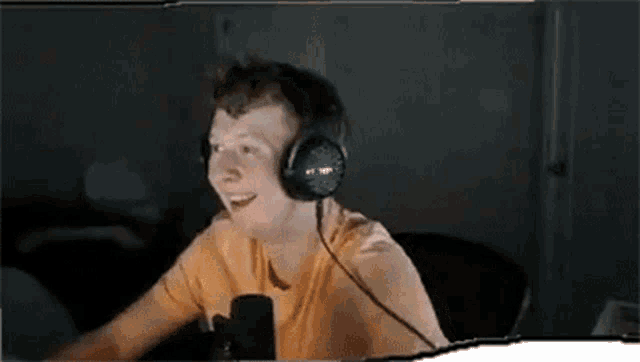 a man wearing headphones is sitting at a table .