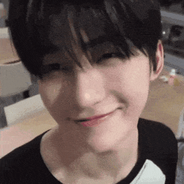 a close up of a person 's face with a slight smile on their face .