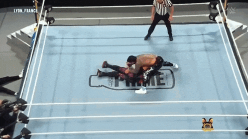 two men are wrestling in a ring with the word prime on it
