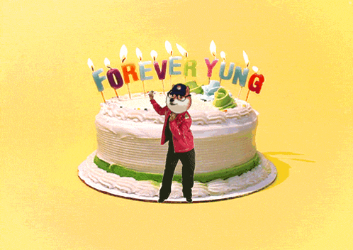 a cake that says forever young with candles on it