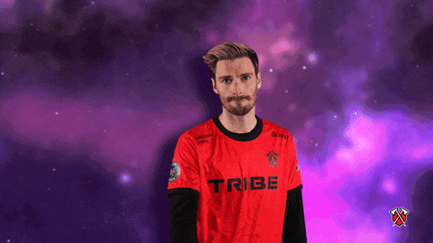 a man wearing a red shirt that says tribe on the front
