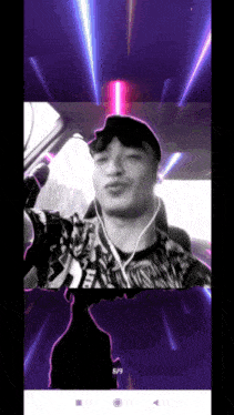 a man in a ufc shirt is taking a selfie in a car