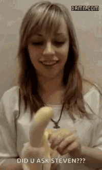 a woman is holding a banana in her hand and smiling .