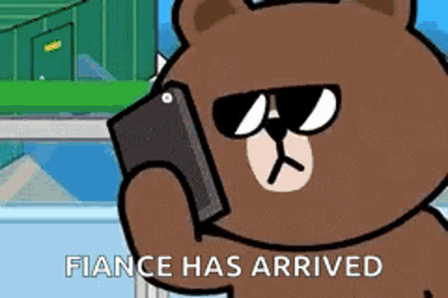 a cartoon bear wearing sunglasses is holding a cell phone in his hand .