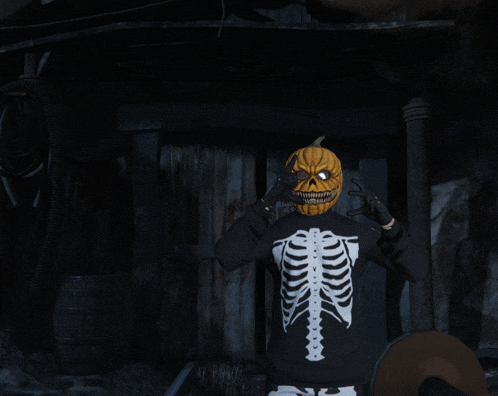 a person wearing a skeleton sweater with a pumpkin mask on their face