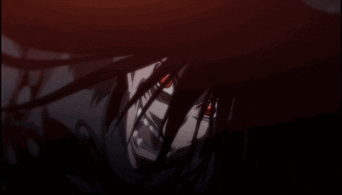 a person in a dark room with a red light coming out of them
