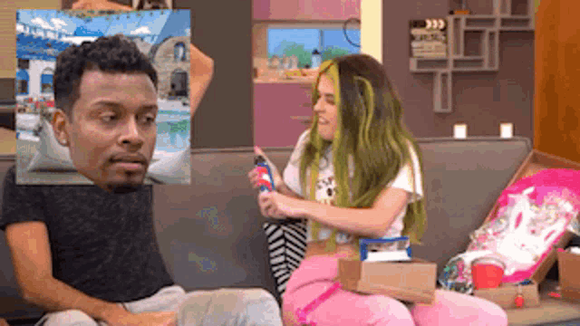 a man and a girl are sitting on a couch playing a video game