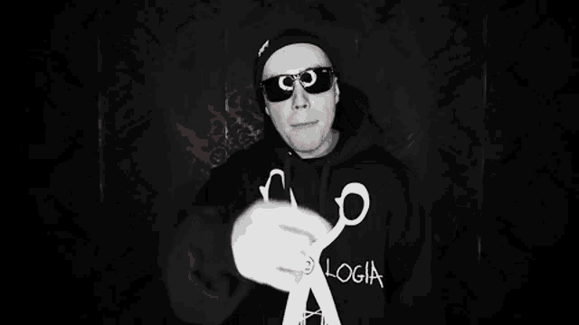 a man wearing sunglasses and a red sweatshirt that says yon login
